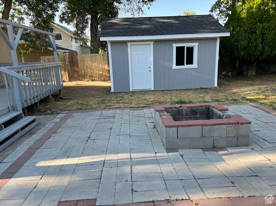 View of outbuilding with an outdoor fire pit