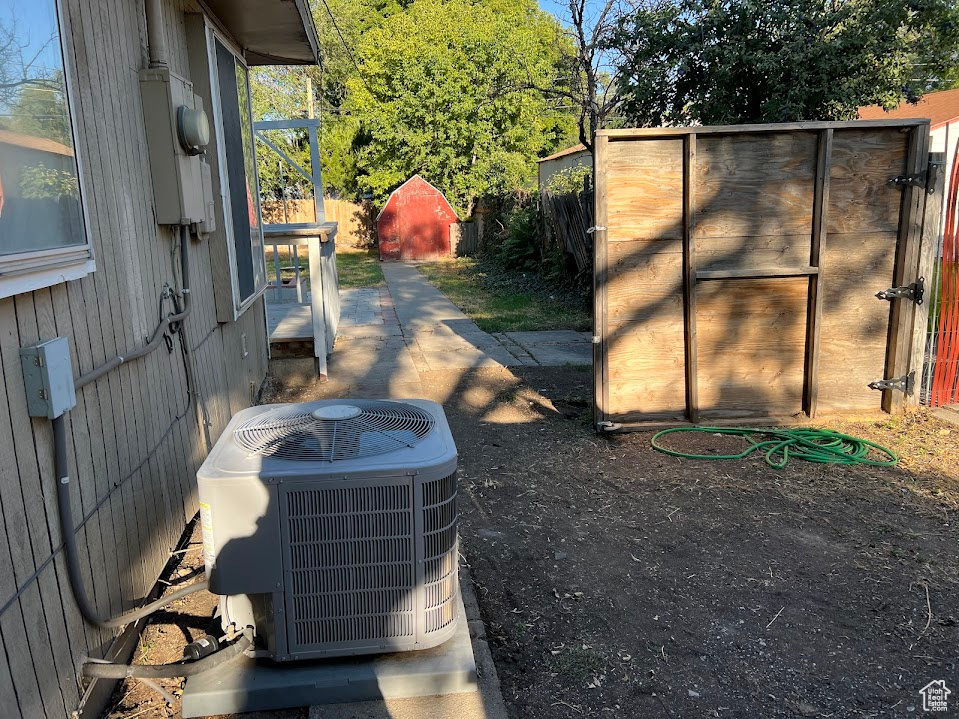 Exterior space with a storage shed and cooling unit