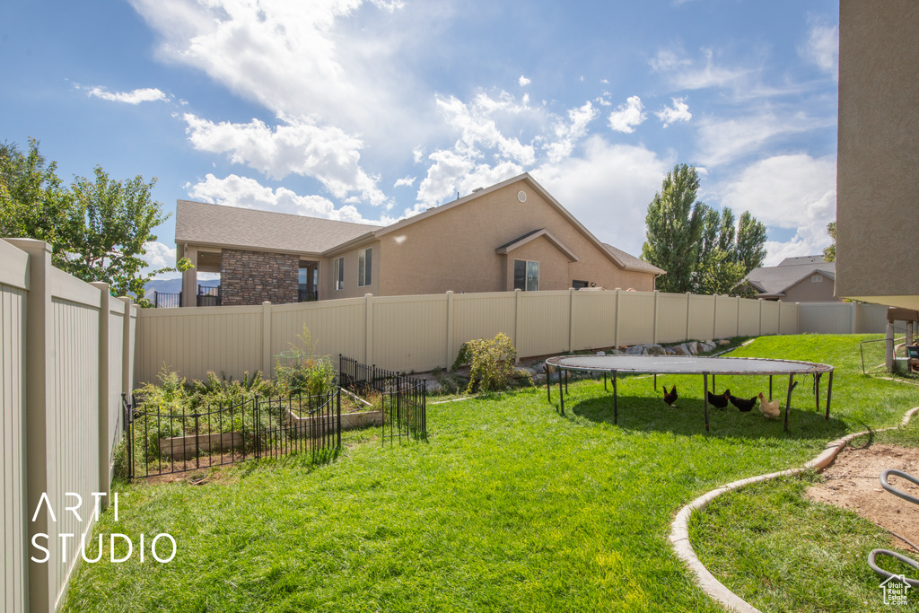 View of yard with a trampoline