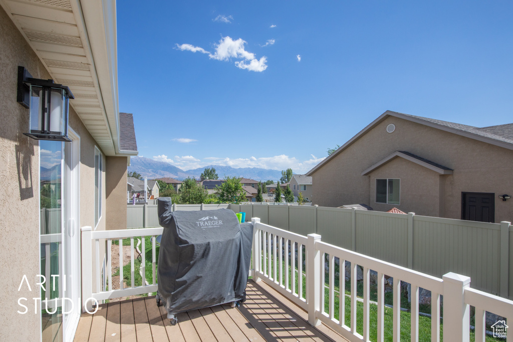 Wooden terrace with grilling area and a mountain view