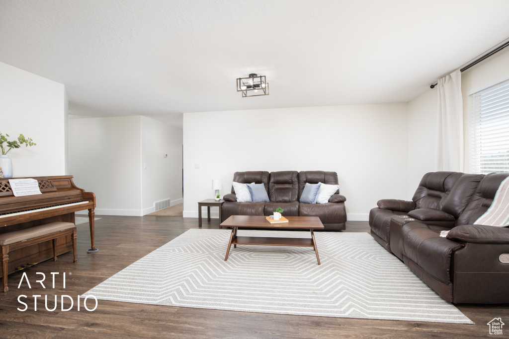 Living room with dark wood-type flooring