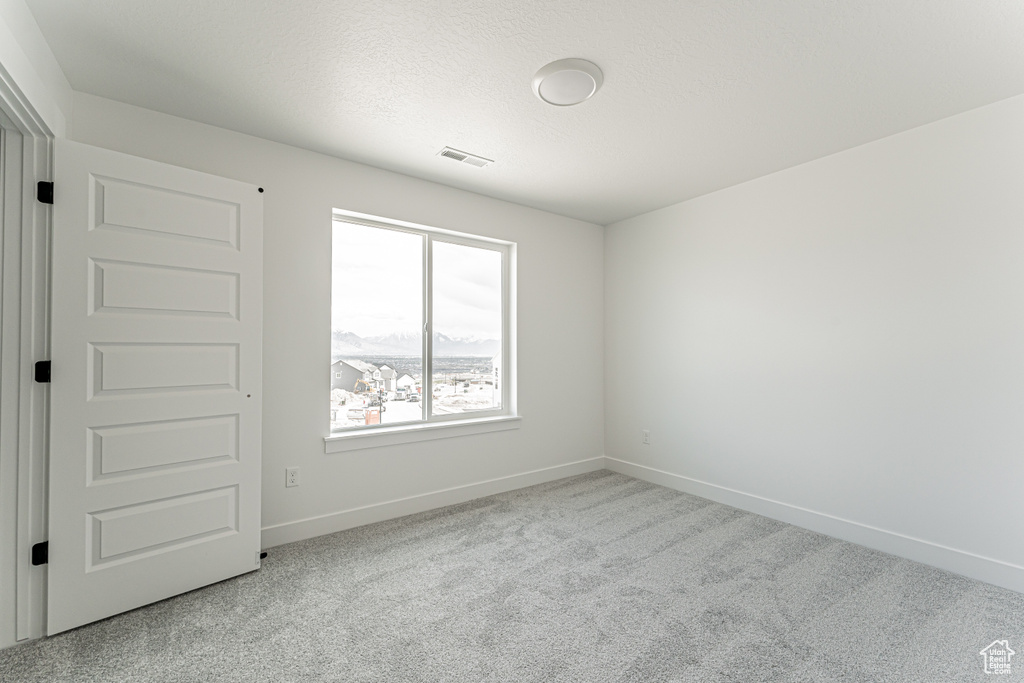 Spare room with carpet flooring and baseboards