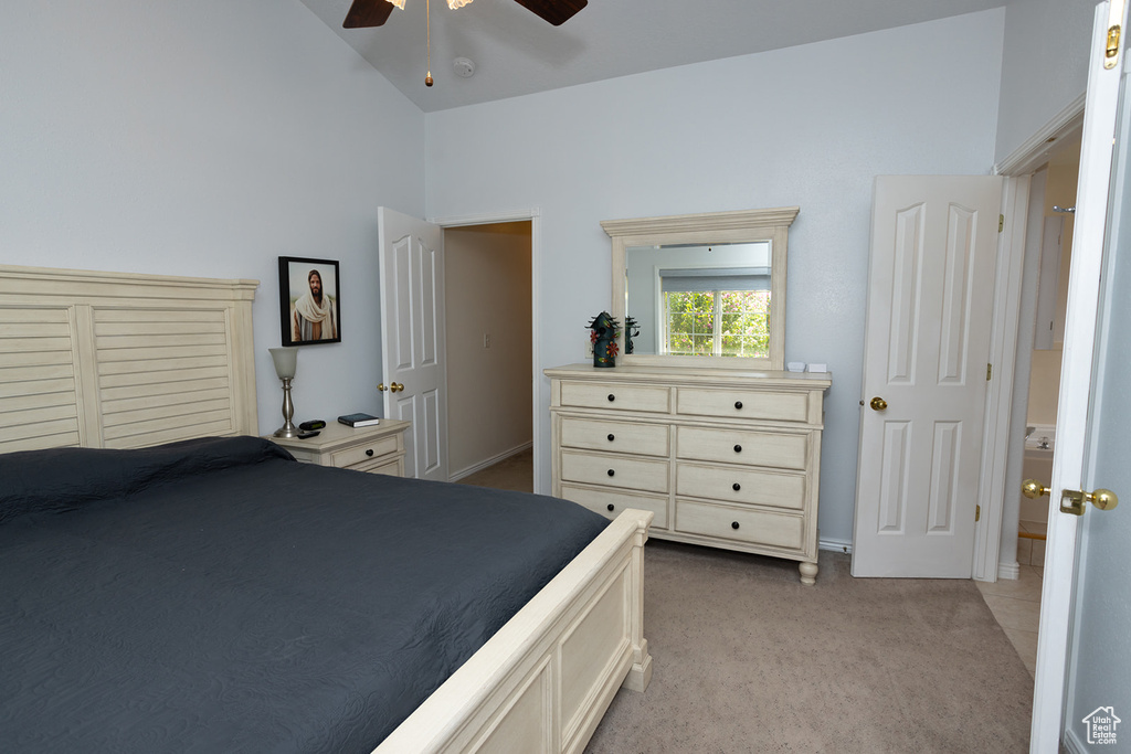 Carpeted bedroom featuring high vaulted ceiling and ceiling fan