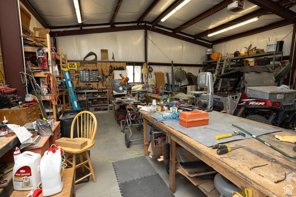 Garage featuring a garage door opener and a workshop area