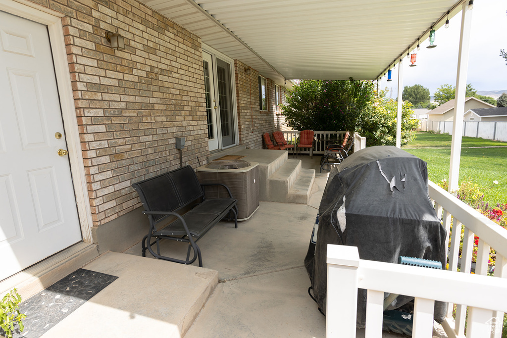 View of patio with central air condition unit and grilling area