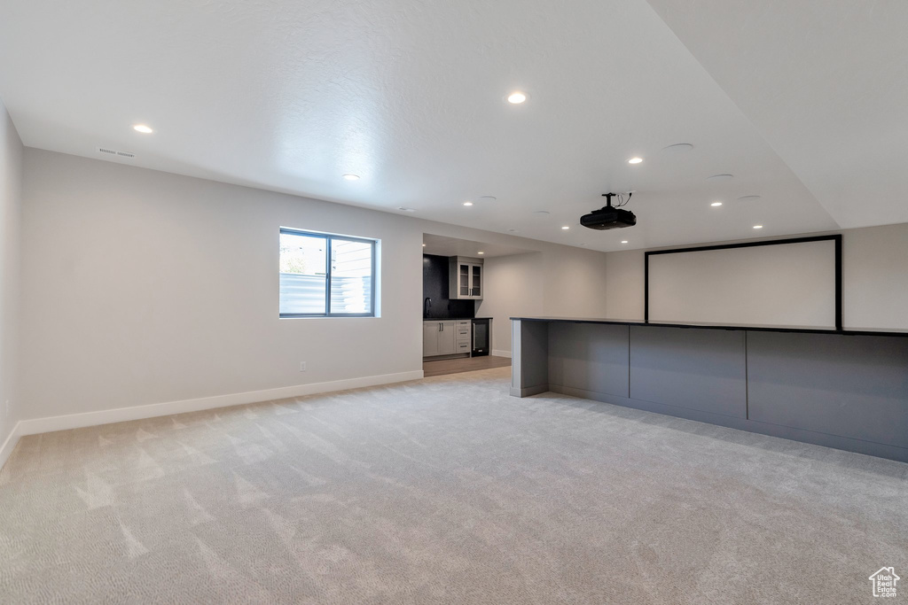 Cinema room featuring light carpet