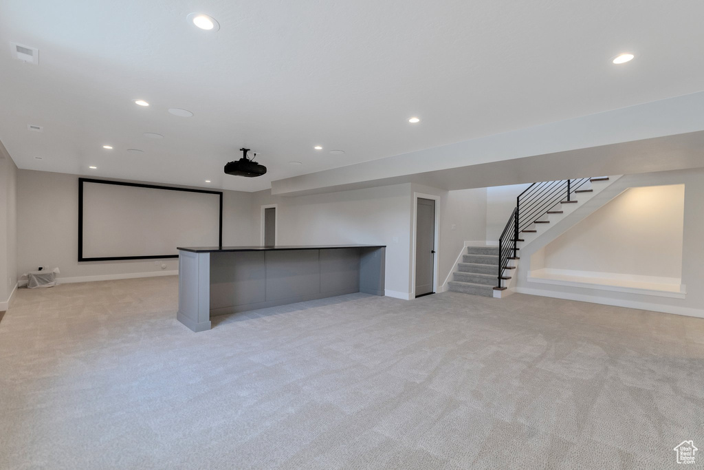 Basement featuring light colored carpet