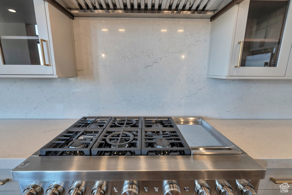 Details with stainless steel range oven and white cabinetry