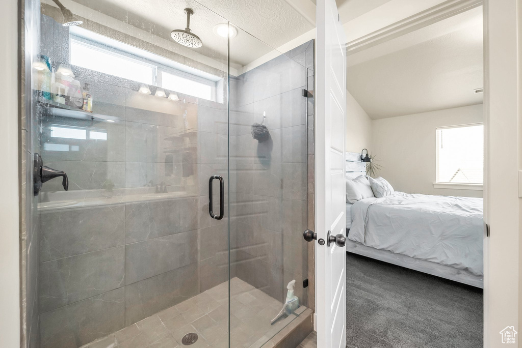 Bathroom with an enclosed shower and a textured ceiling