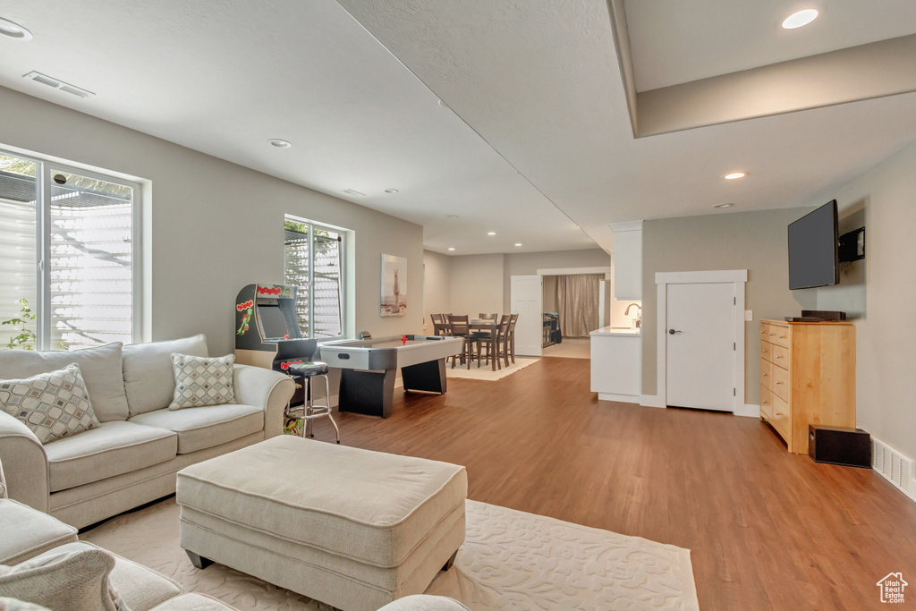 Living room with light hardwood / wood-style floors