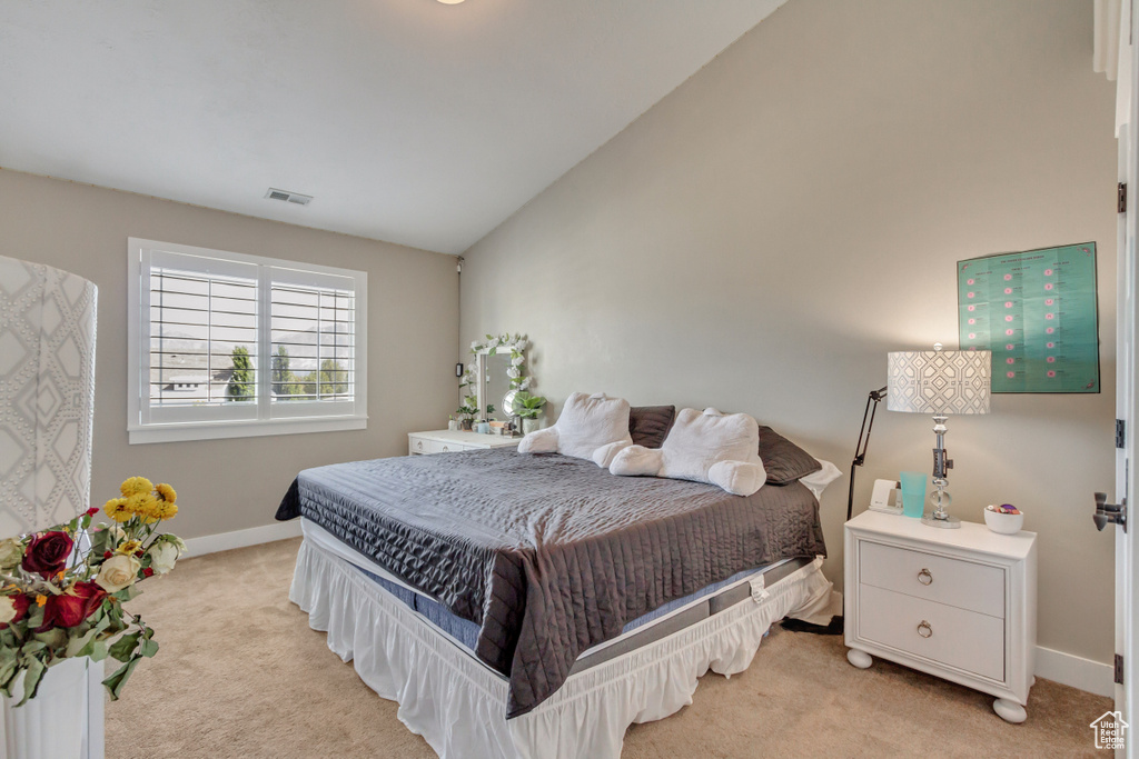 Carpeted bedroom with vaulted ceiling