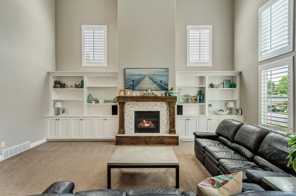 Living room featuring light carpet and a towering ceiling