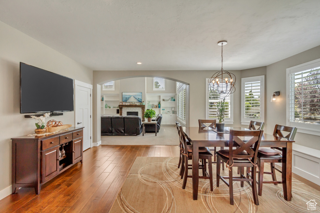 Dining space with a notable chandelier and light hardwood / wood-style flooring