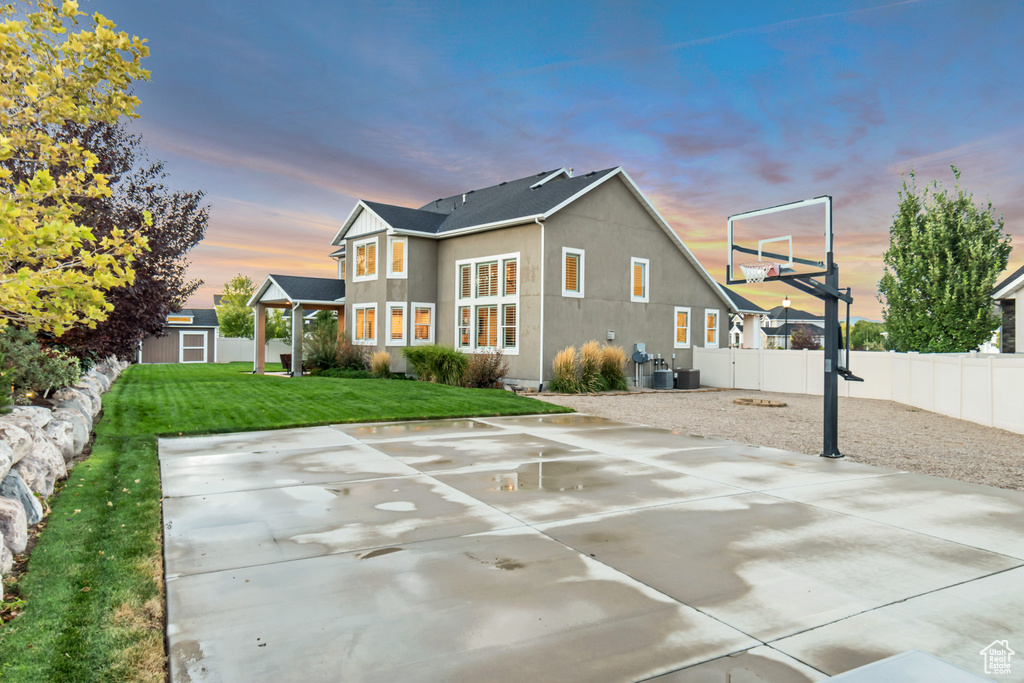 View of sport court with a yard