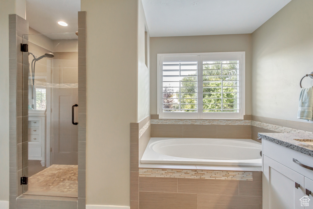 Bathroom with shower with separate bathtub and vanity