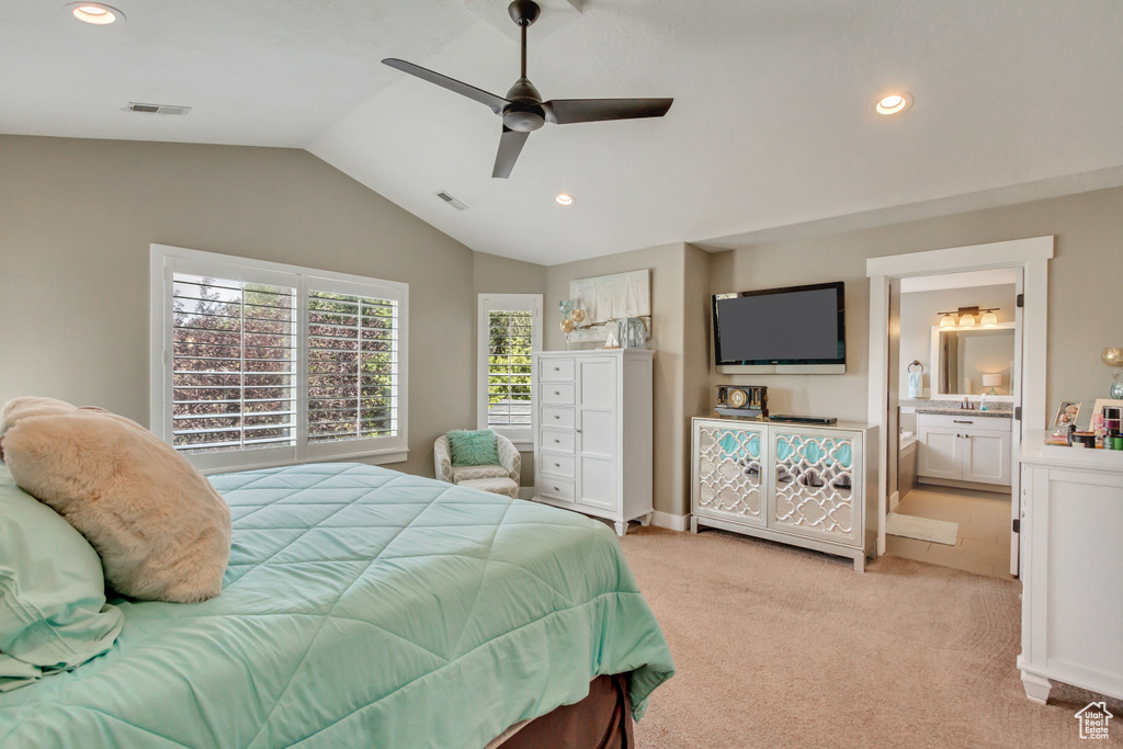 Carpeted bedroom featuring lofted ceiling, ceiling fan, and ensuite bathroom