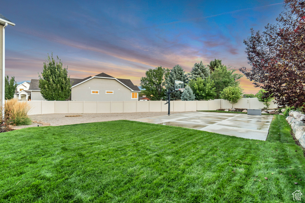 Yard at dusk with basketball hoop