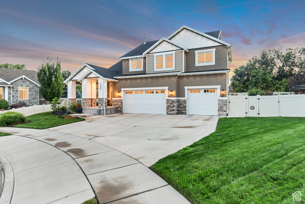 Craftsman-style house with a garage and a lawn