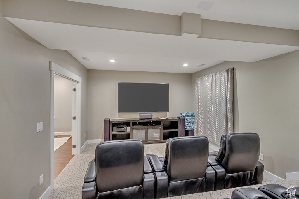 Home theater room with hardwood / wood-style flooring