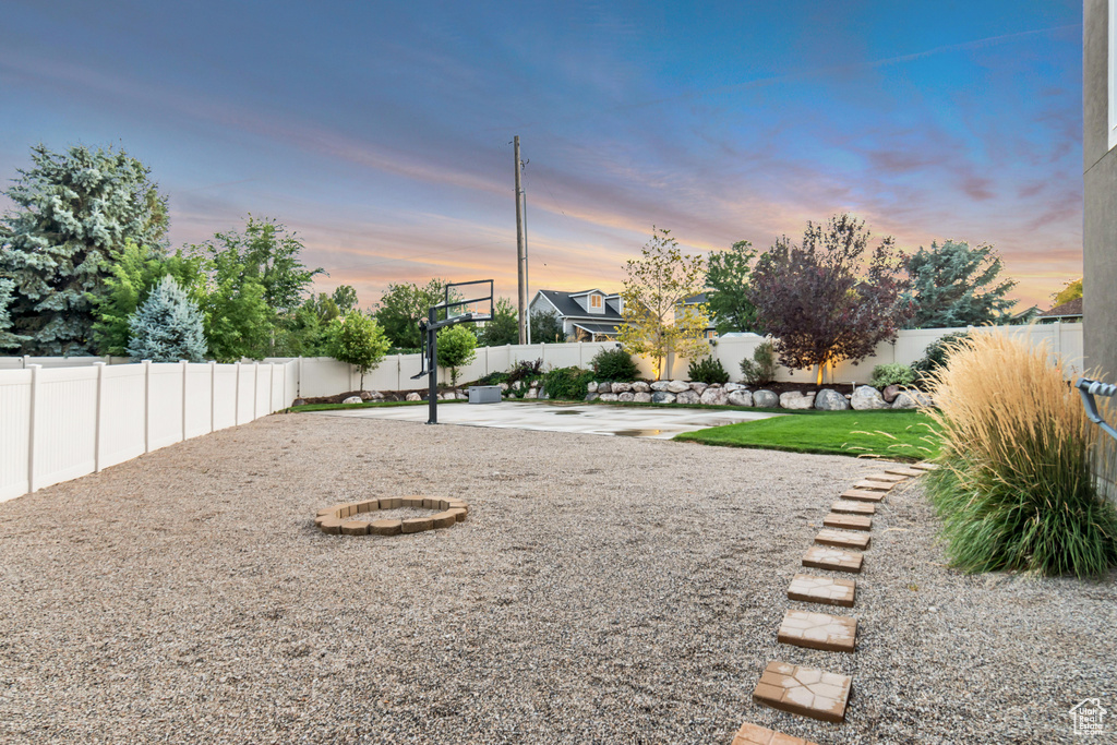 Yard at dusk with an outdoor fire pit