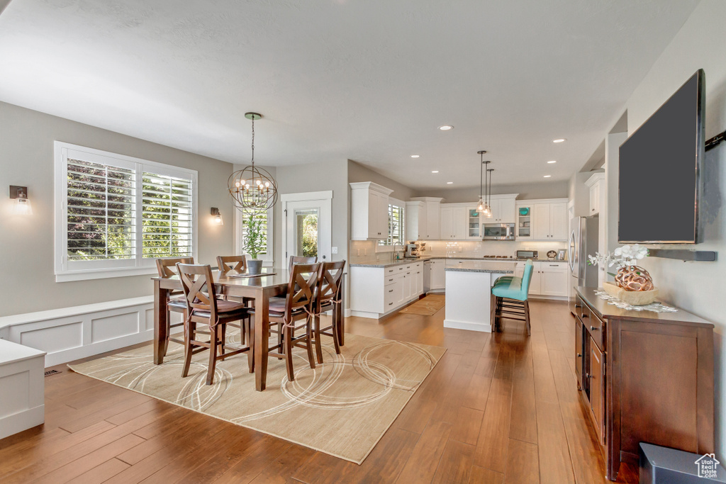 Dining area with a chandelier and light hardwood / wood-style floors