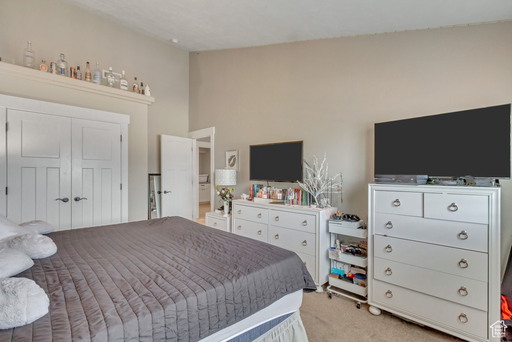 Bedroom featuring light carpet