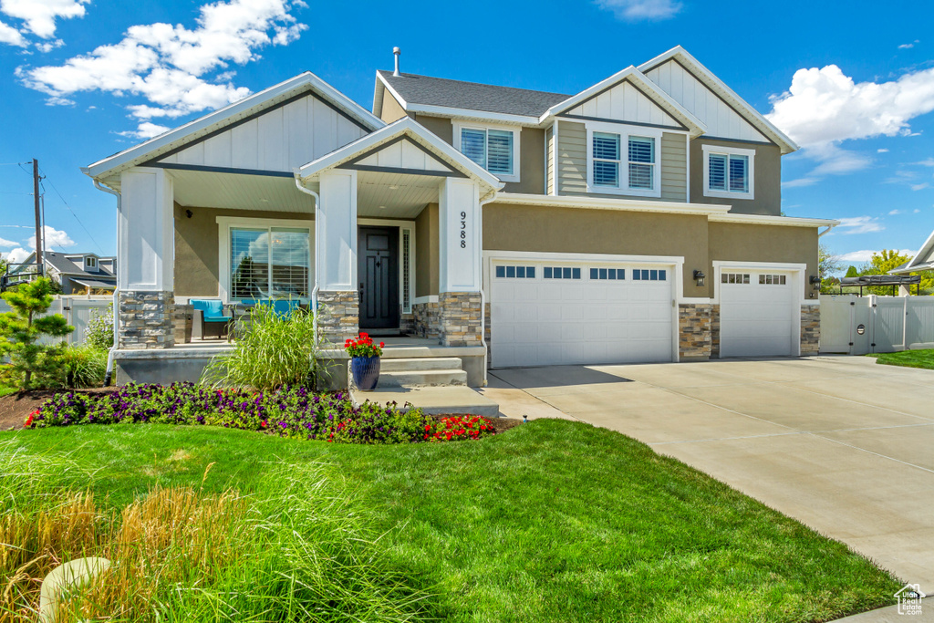 Craftsman-style home with a garage and a front yard