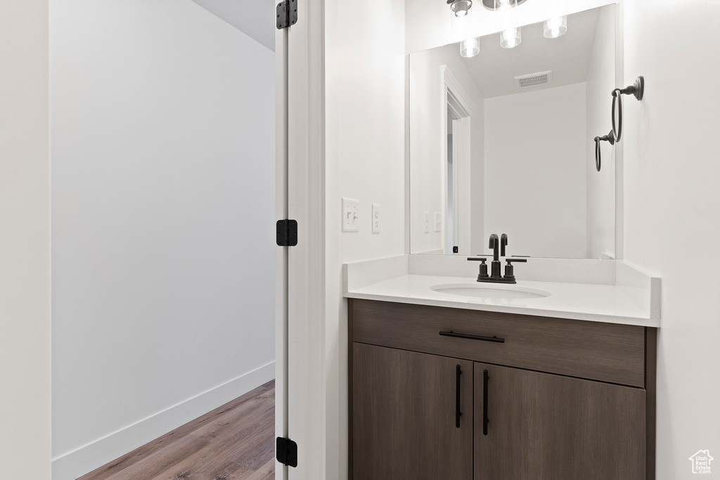 Bathroom with vanity and hardwood / wood-style floors