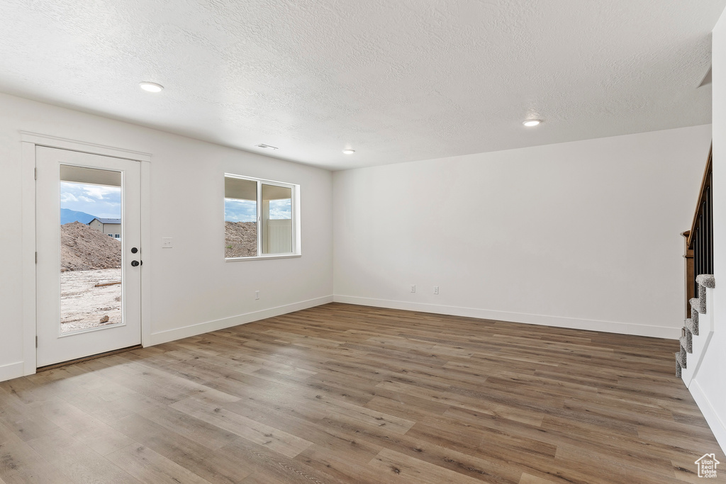 Interior space featuring hardwood / wood-style flooring and a textured ceiling