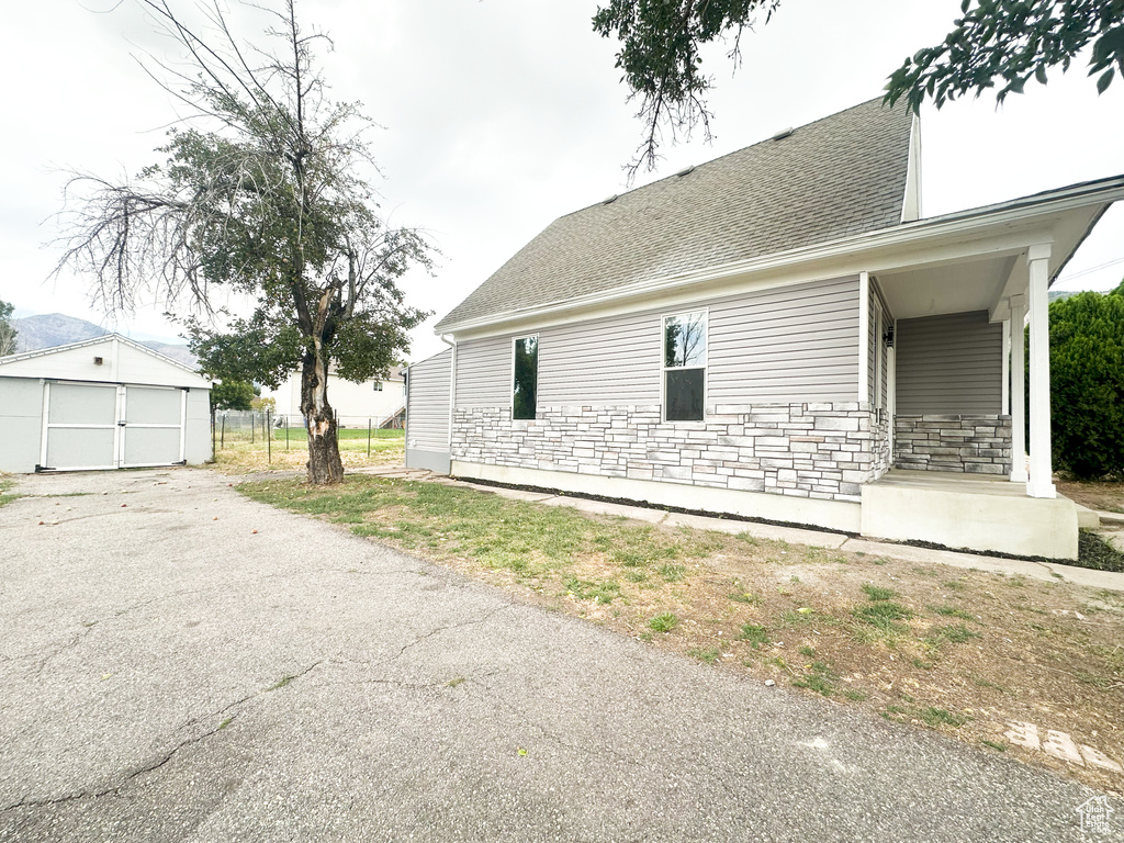 View of side of home with a garage and an outdoor structure