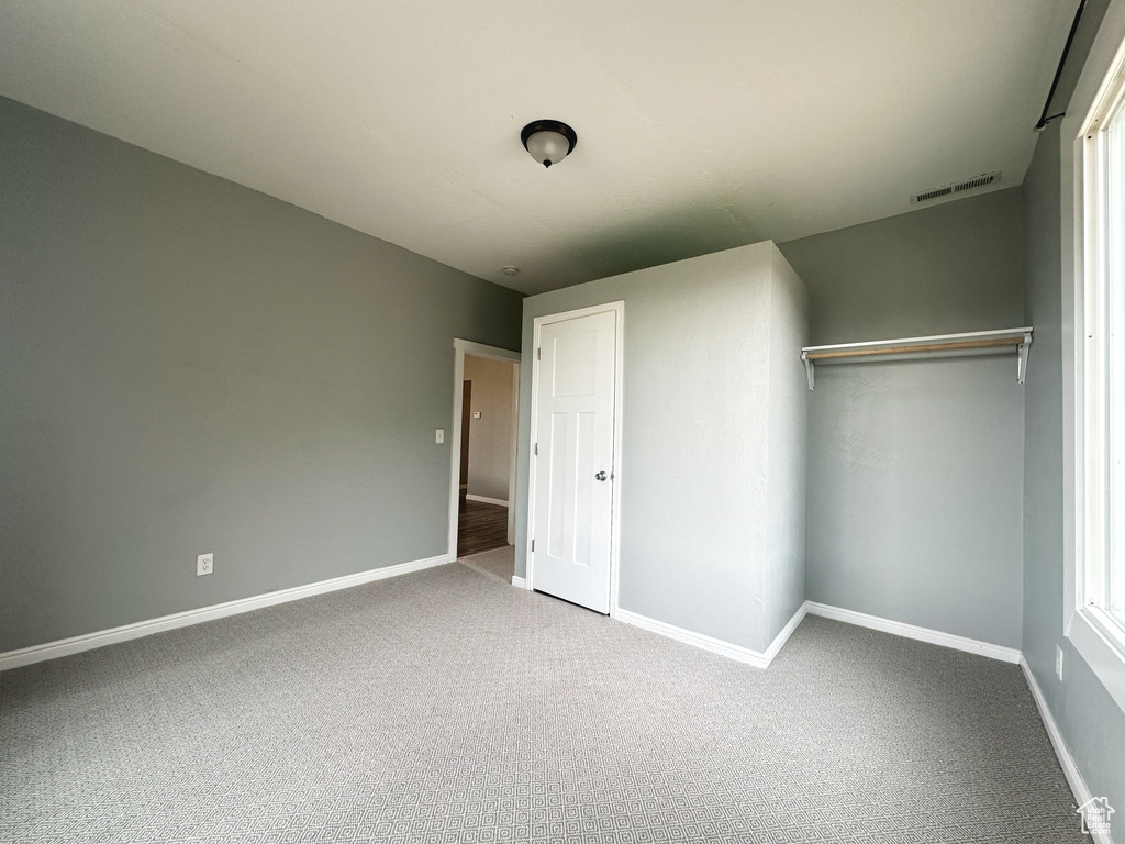 Unfurnished bedroom with carpet floors and a closet