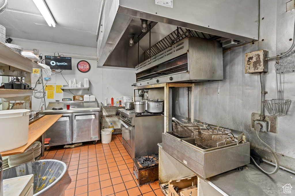 Kitchen with exhaust hood and light tile patterned floors