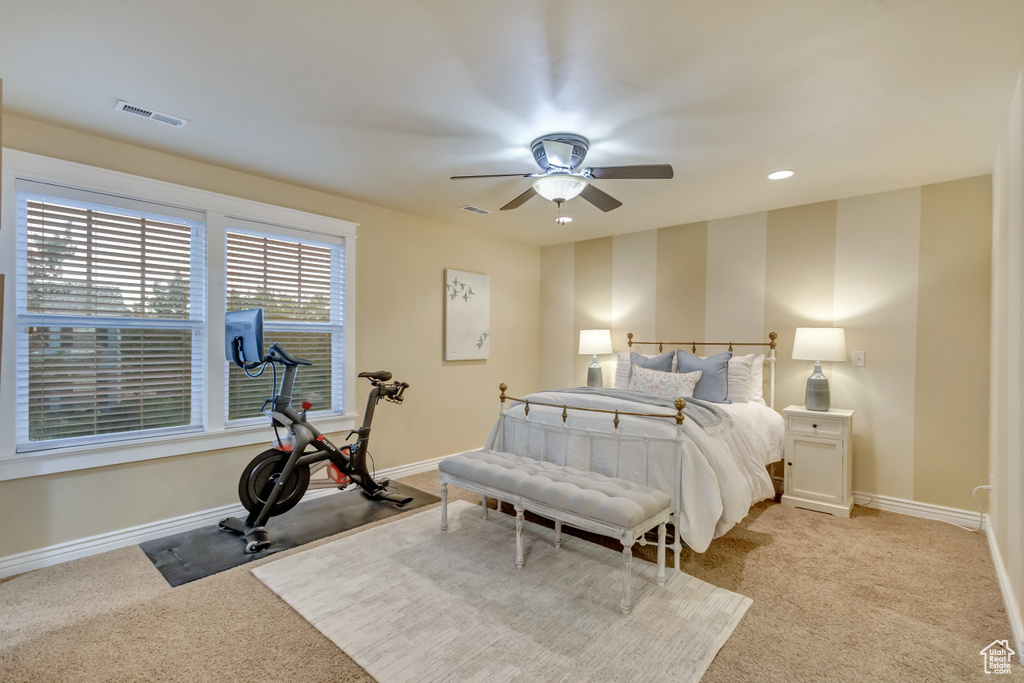 Bedroom featuring light colored carpet and ceiling fan