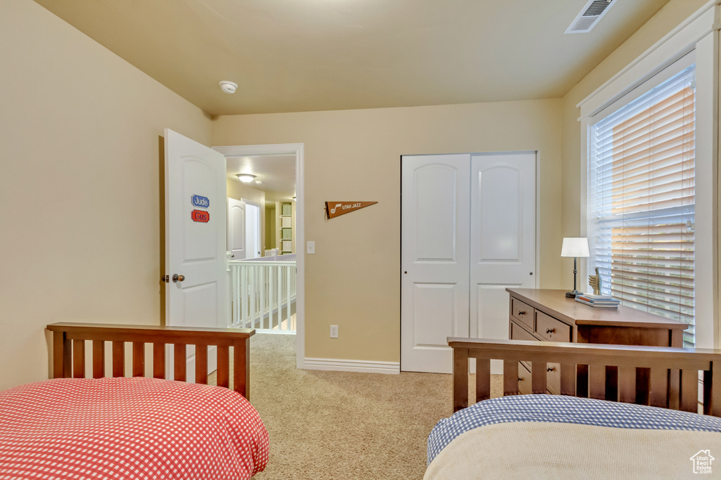 Bedroom with carpet flooring and a closet