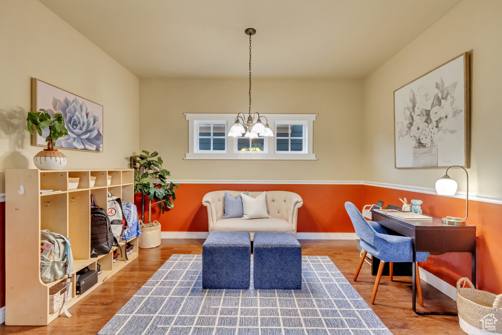 Living area featuring a notable chandelier and hardwood / wood-style floors