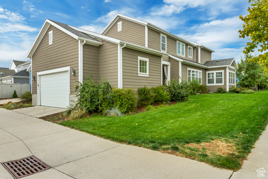 Exterior space with a yard and a garage