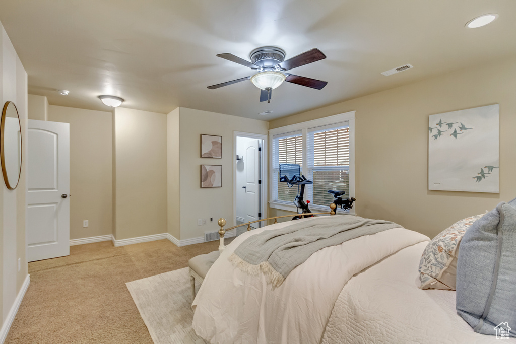 Bedroom with light colored carpet and ceiling fan