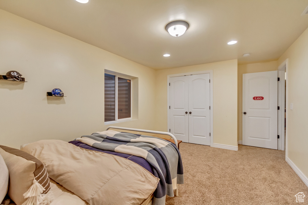 Bedroom featuring a closet and light carpet