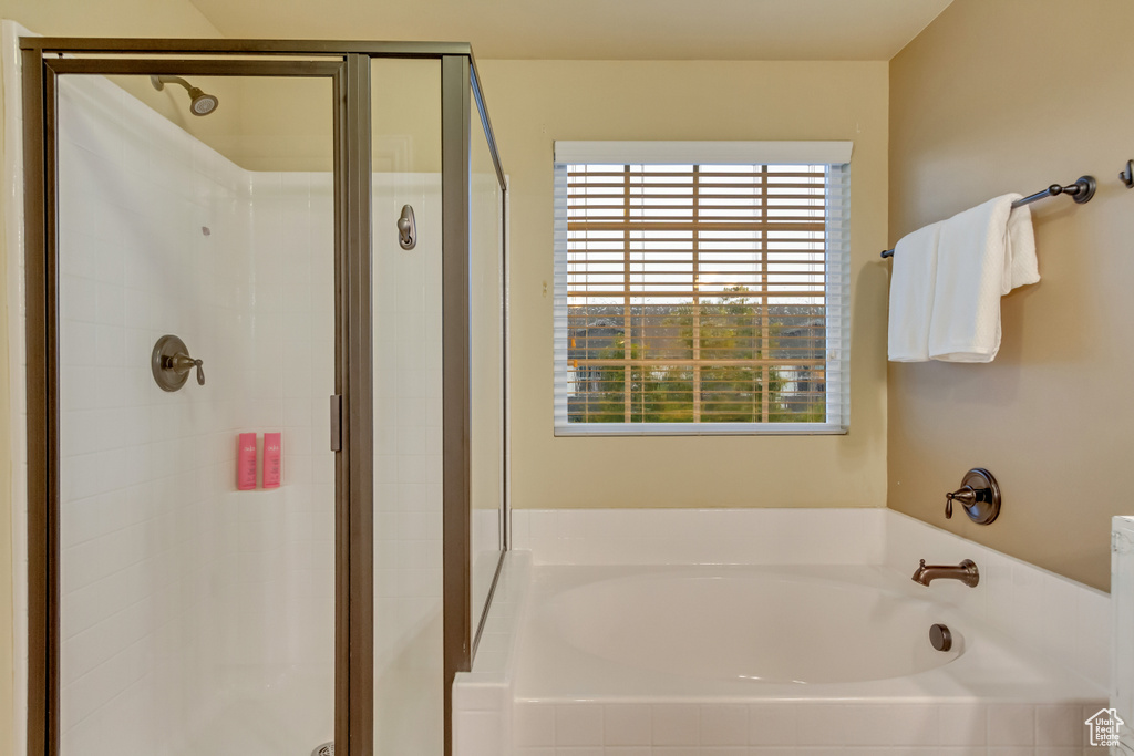 Bathroom featuring shower with separate bathtub