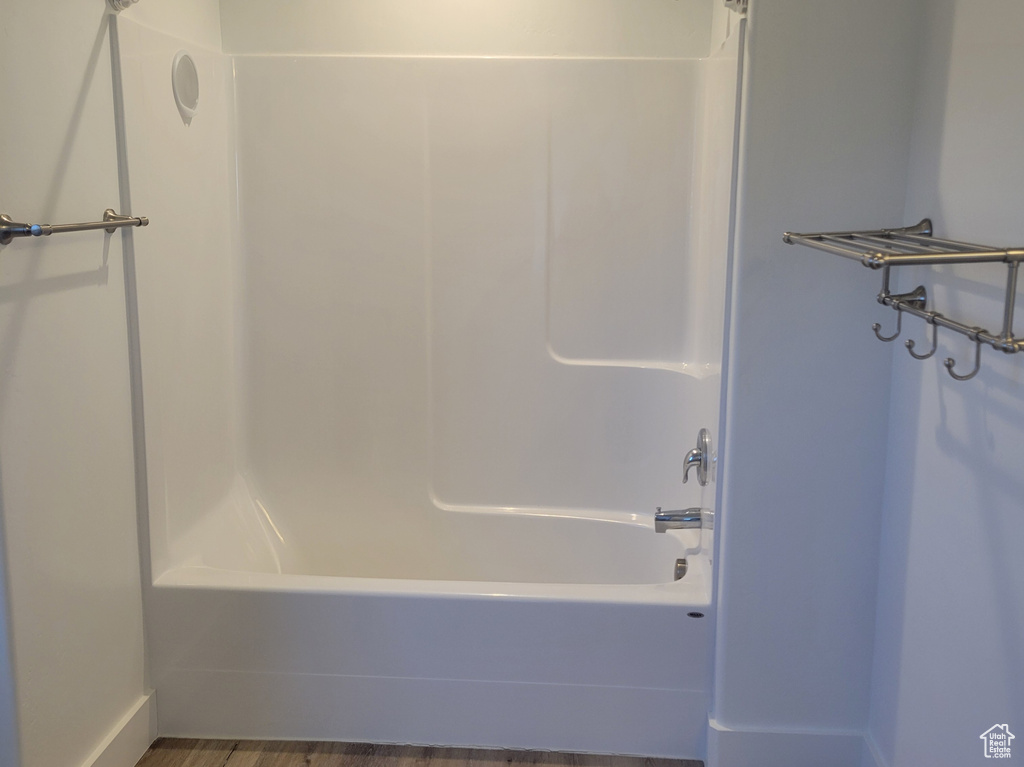 Bathroom with shower / bath combination, recessed lighting, baseboards, and wood finished floors