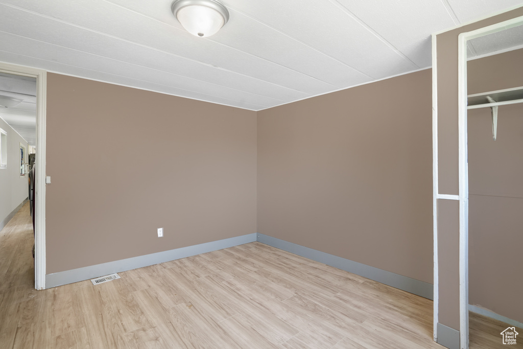 Unfurnished bedroom featuring light wood-type flooring