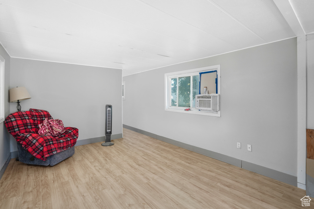 Unfurnished room featuring cooling unit and light hardwood / wood-style floors