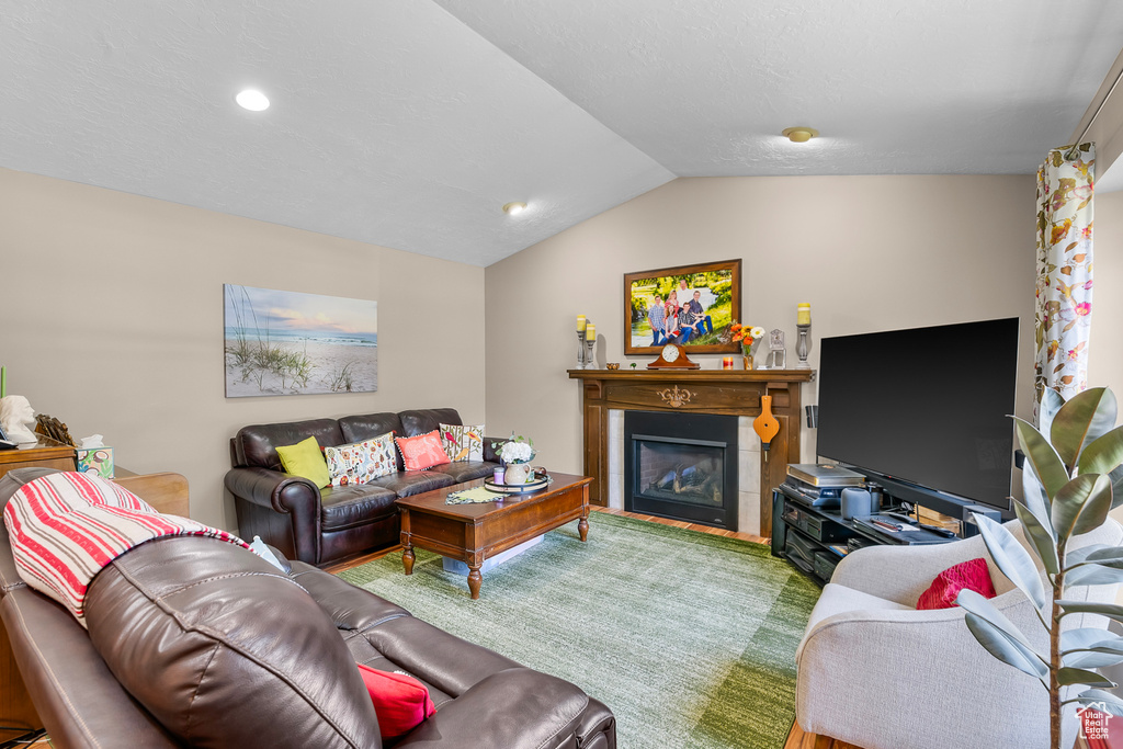 Living room featuring lofted ceiling and carpet