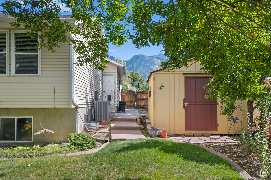 View of yard featuring a mountain view and a storage unit