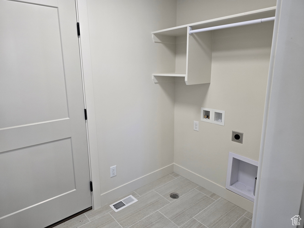 Washroom featuring hookup for an electric dryer and washer hookup