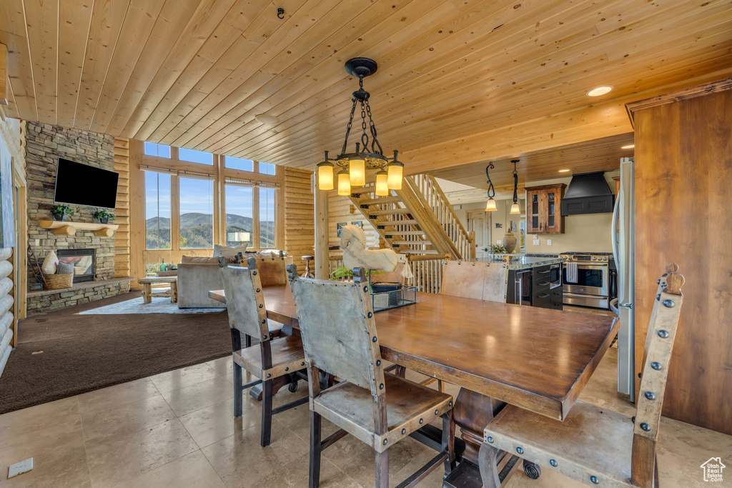 Dining space with wooden ceiling and a fireplace