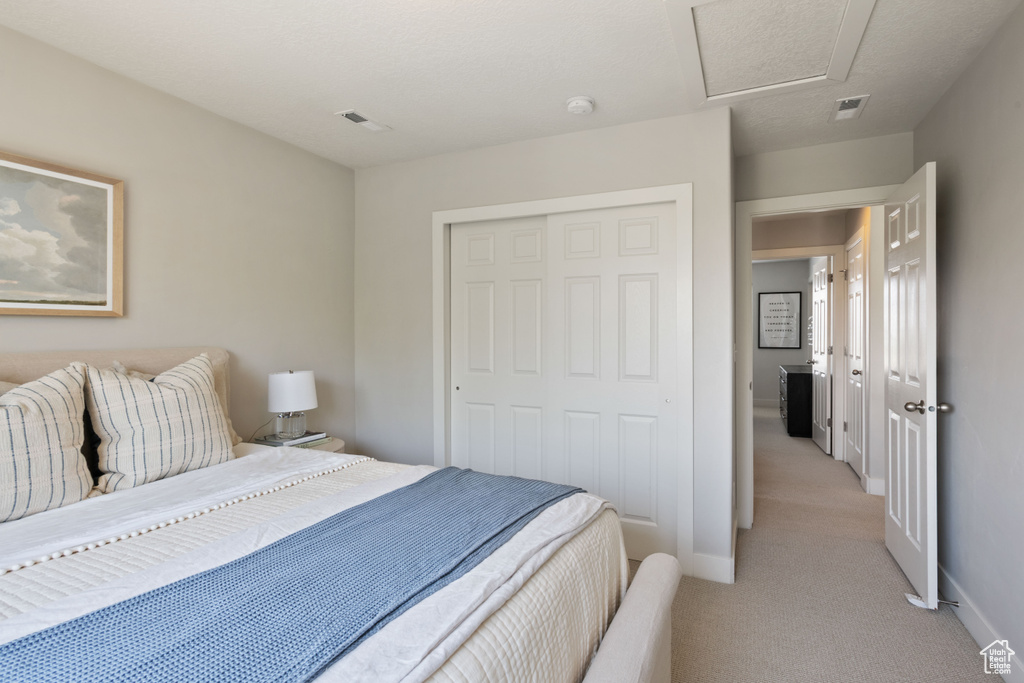 Bedroom featuring a closet and light carpet