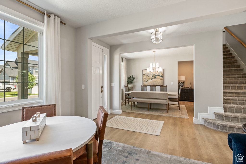 Dining room featuring light hardwood / wood-style flooring and a notable chandelier