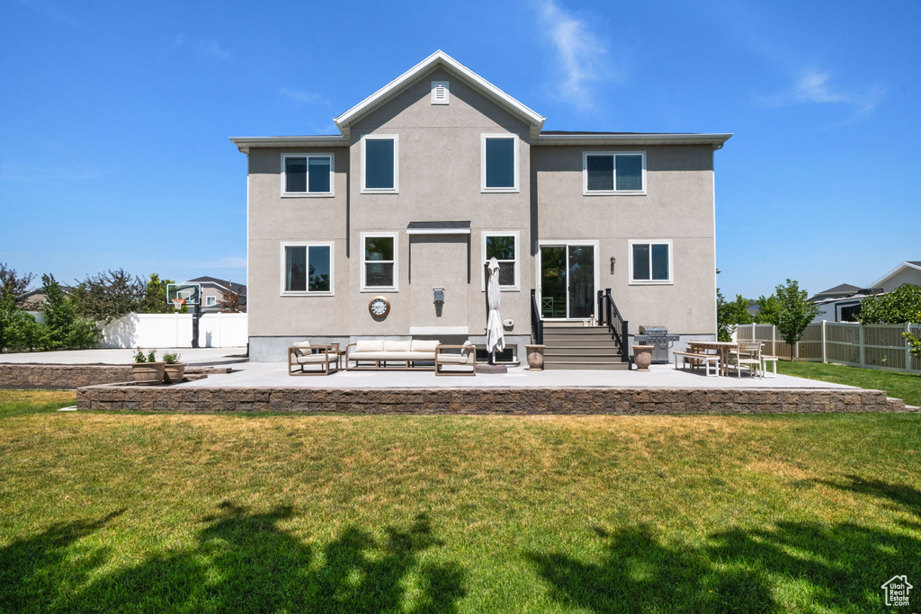 Rear view of house with a patio area, a yard, and outdoor lounge area