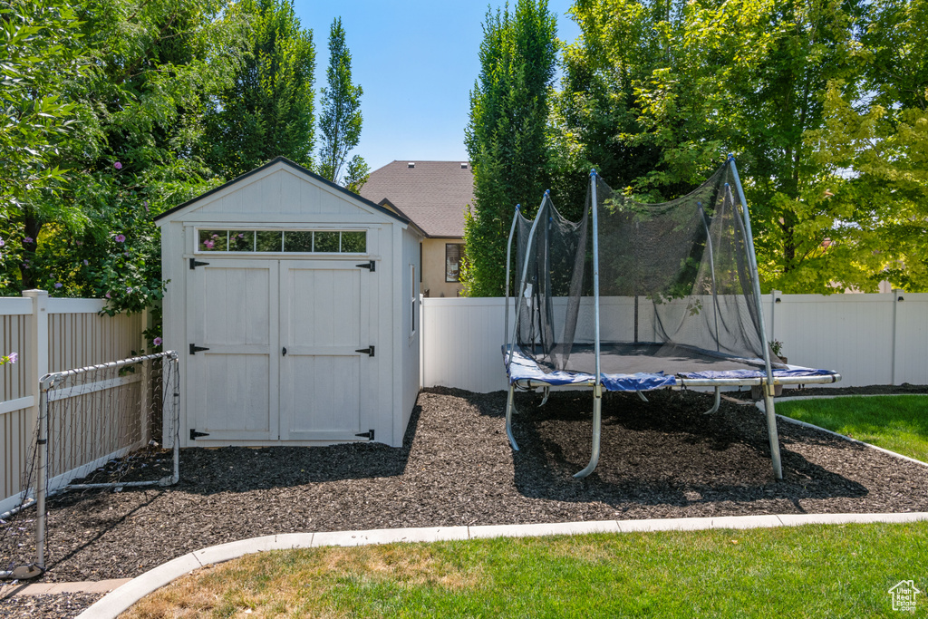 Exterior space featuring a storage unit and a trampoline